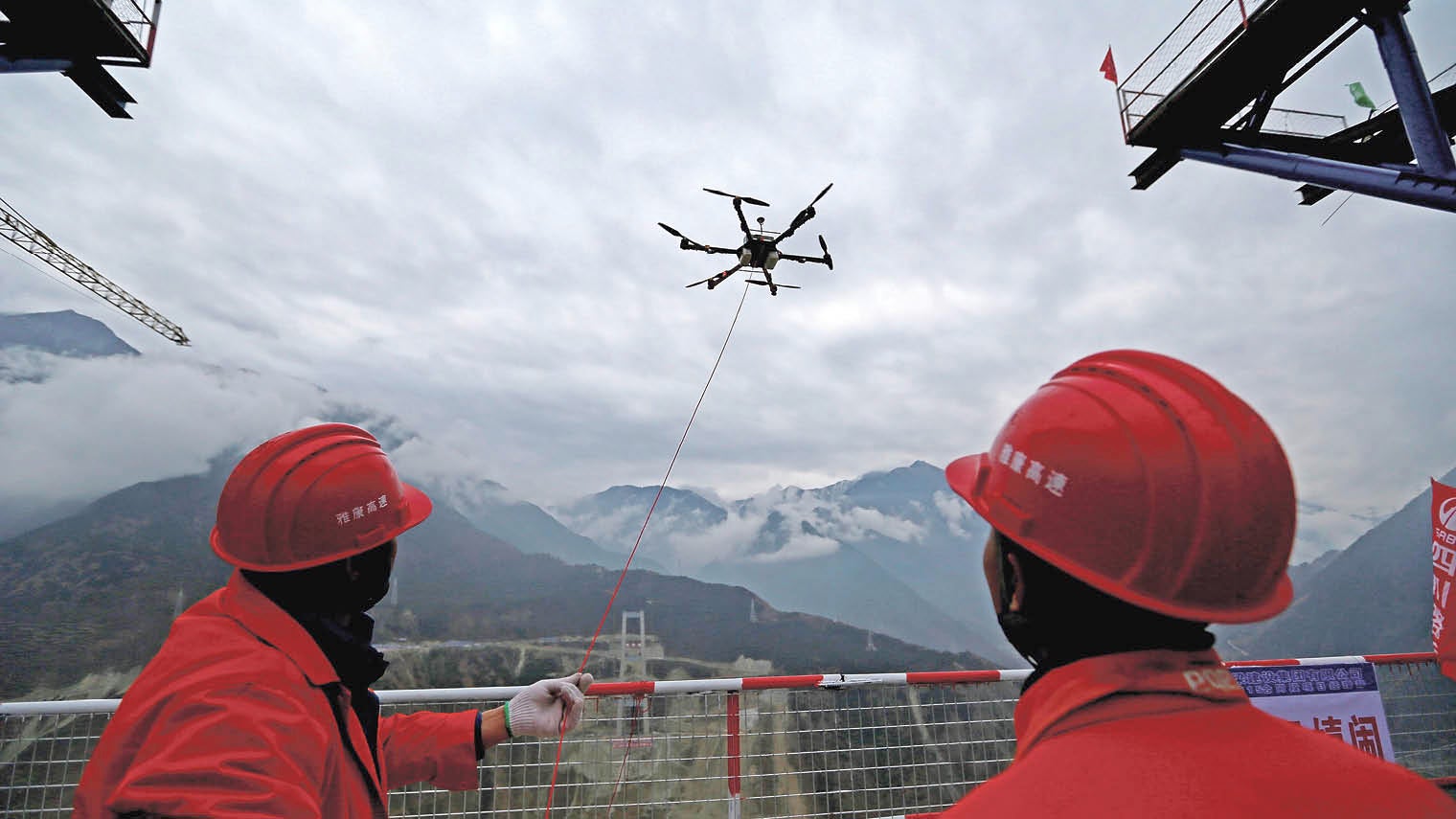 A drone towing a cable over the Dadu River in the construction of a 1.1km bridge in Ya’an, Sichuan Province, China