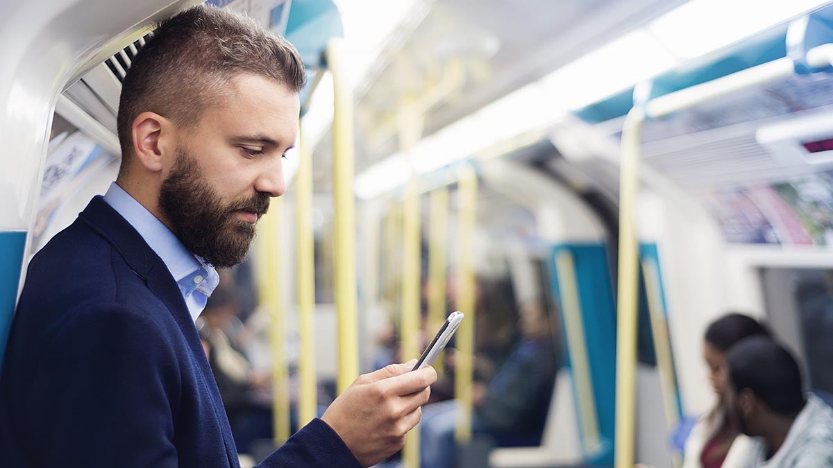 man using phone on terain