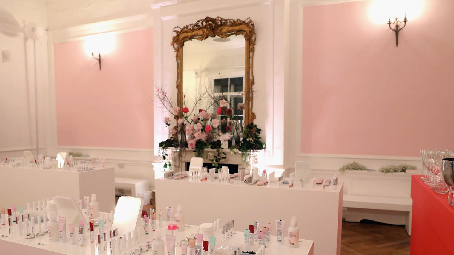 Glossier interactive brand experience with make up laid on tables