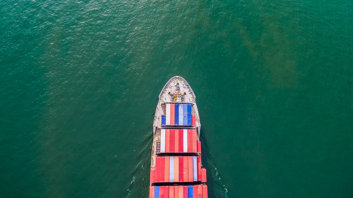 aeriel view container shipping by container ship by green sea .