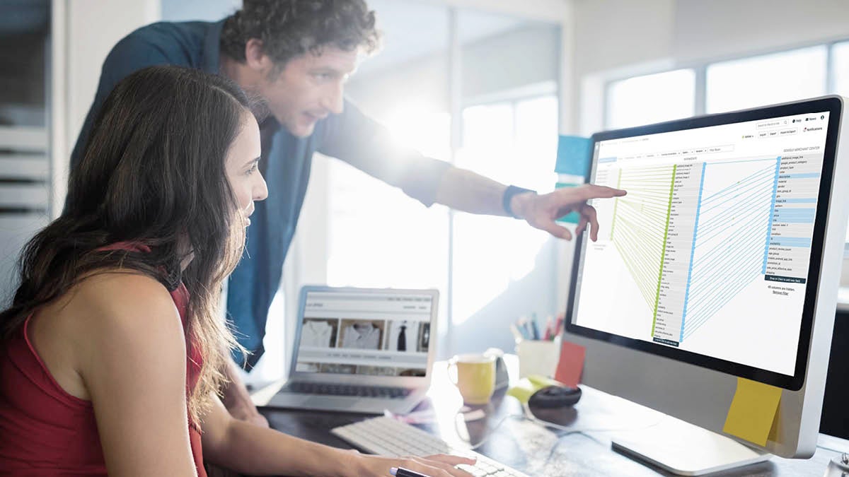 man and woman looking at laptop