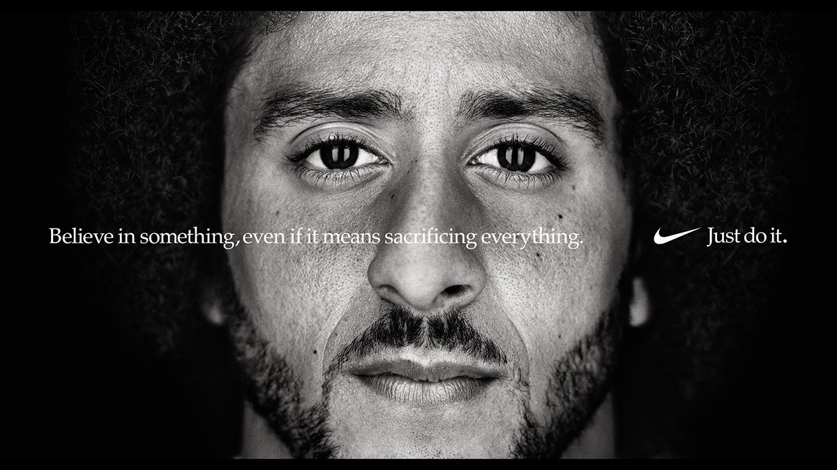 Portrait of NFL player Colin Kaepernick with the phrase 'Believe in something, even if it means sacrificing everything. Just do it. Nike'