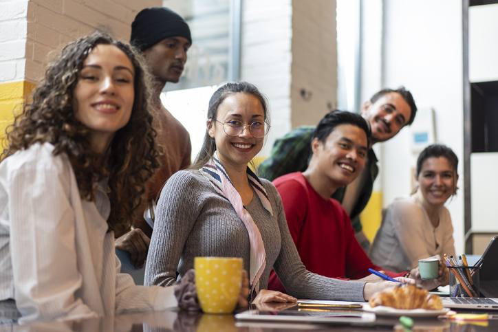 Young Co Workers Or University Students Multiethnic Team Planning A New Startup Bright Filter With Focus On Second Woman Face On Left