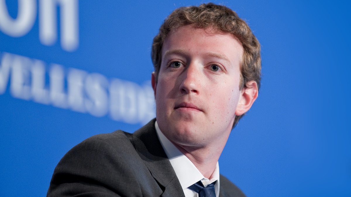 Mark Zuckerberg, CEO of Meta, attending a technology conference and listening attentively during a panel discussion.
