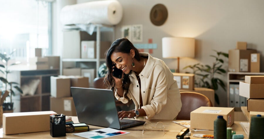 Phone Call, Small Business Or Happy Woman With Laptop For Ecommerce Communication In Office. Typing, Smile Or Indian Manager Listening In Conversation Or Speaking Of News, Feedback Or Networking