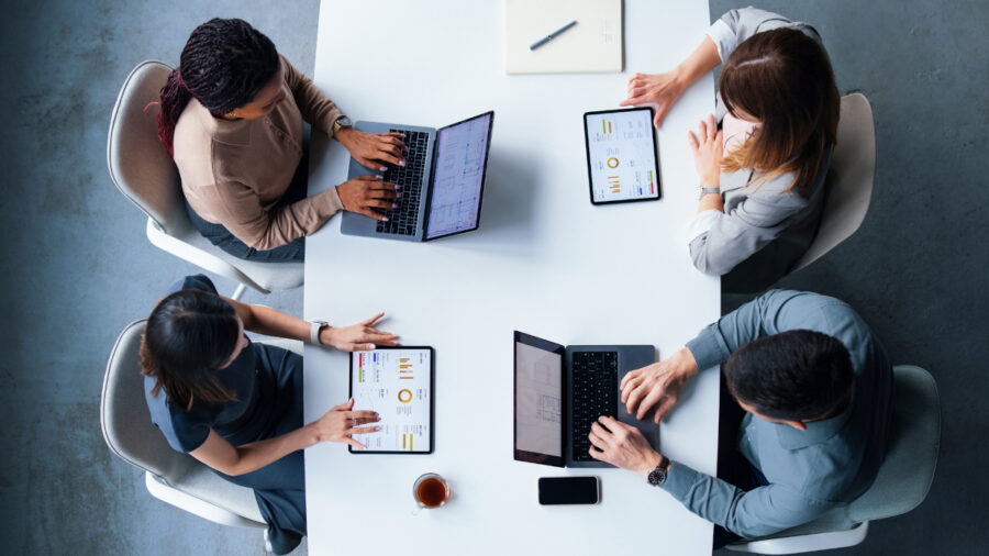 Top View Of Professionals Collaborating In A Modern Office Meeting
