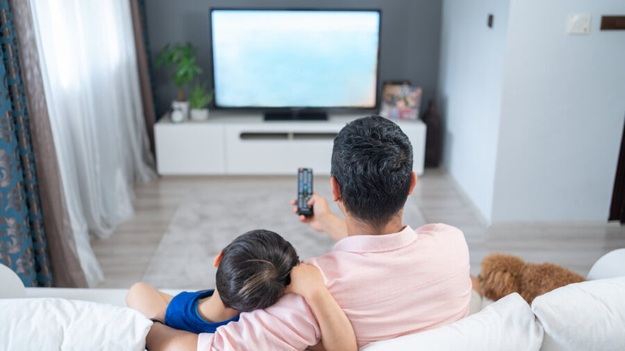 Father and son watching TV together